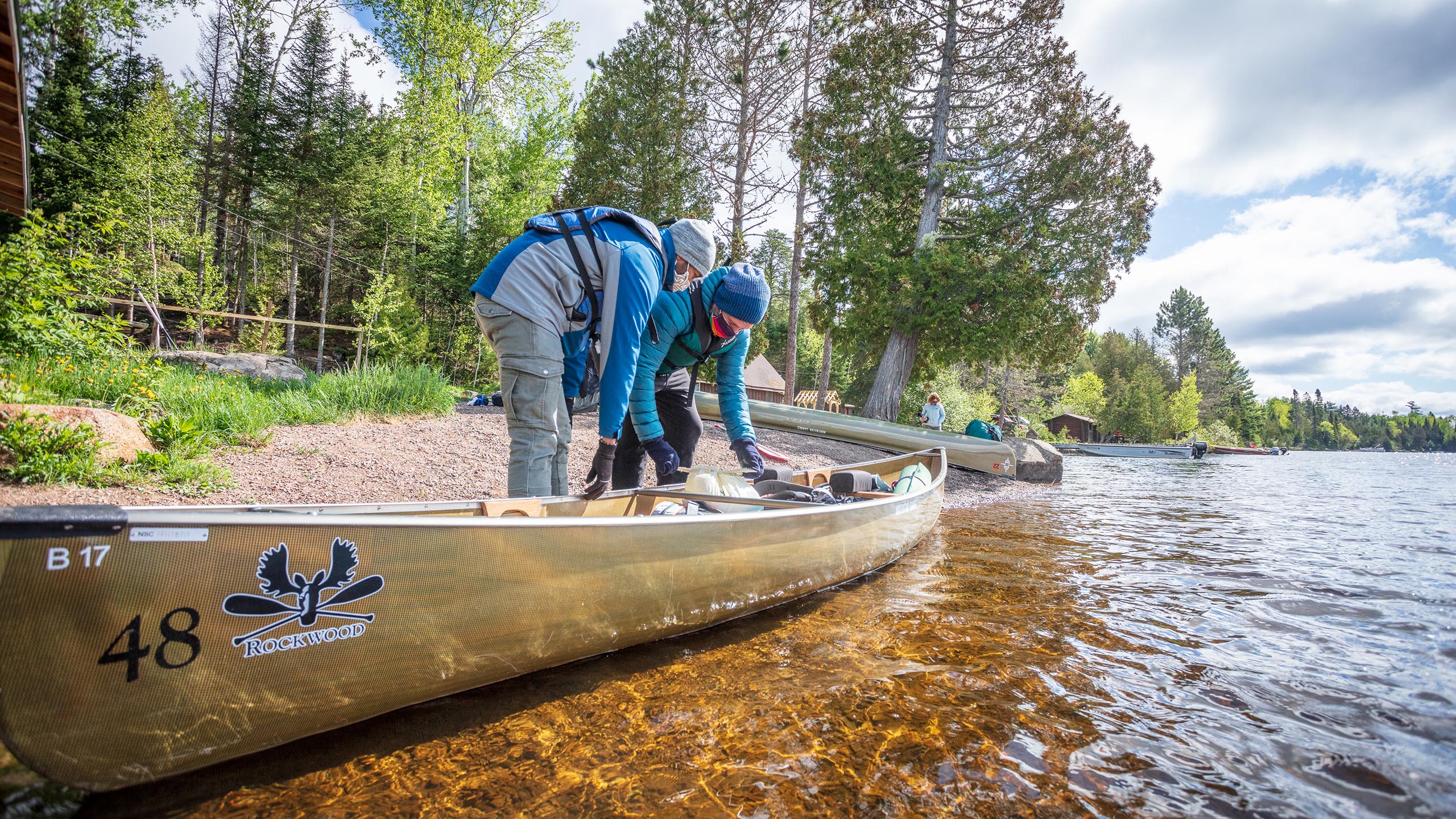 two people preparing their kevlar canoe for the boundary waters bwca