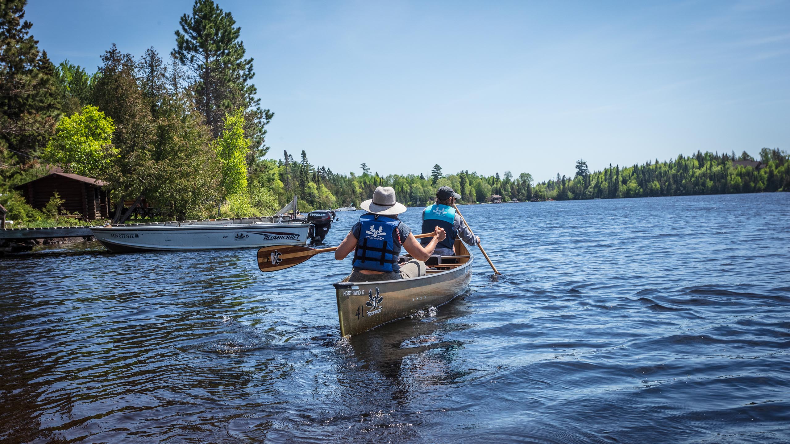 two people in a canoe preparing to enter the boundary waters