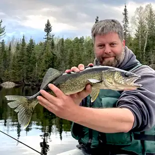 Rockwood--Rockwood Lodge and Outfitters 14 mike holding a poplar lake walleye