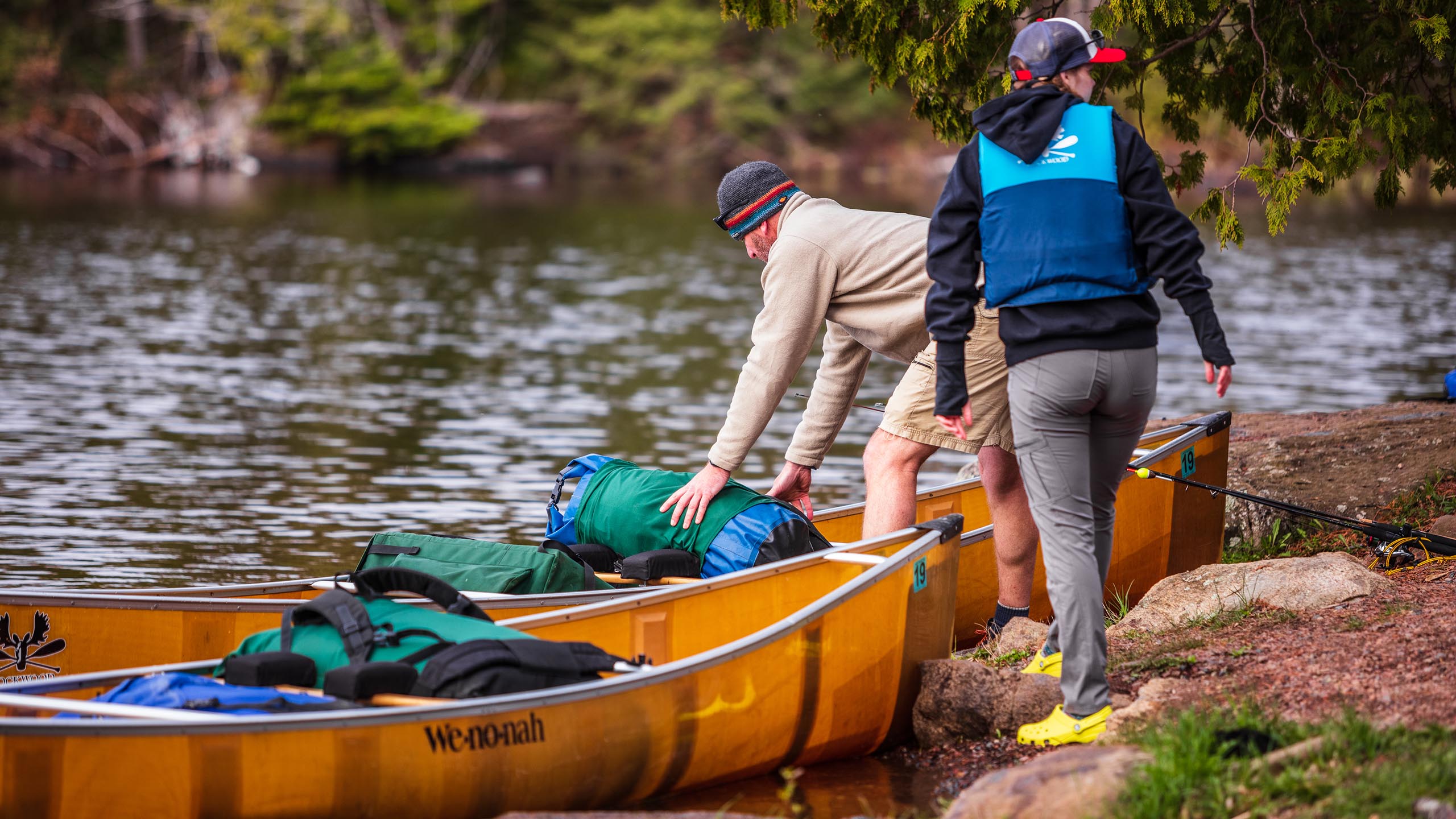 two people preparing for a boundary waters canoe trip using kevlar canoes