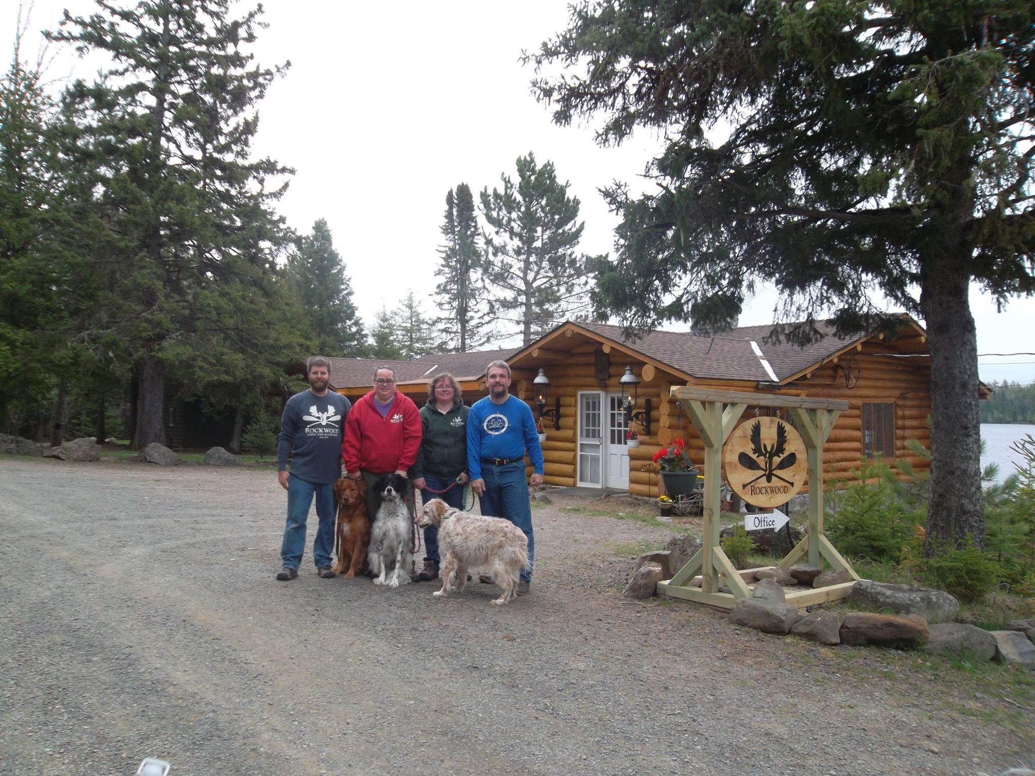 Rockwood team with dogs in front of lodge